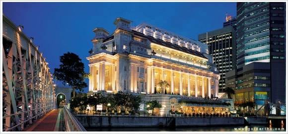 The Fullerton Hotel, a large building in the middle of a city at night, invites you to go global.