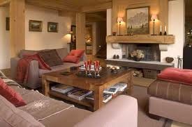 A luxurious living room with couches and a fireplace.