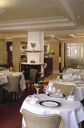 A splendid restaurant with white tablecloths and chairs.