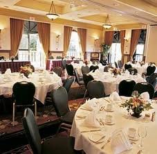 A banquet room with tables and chairs set up in the luxurious Hotel Grand Pacific at British Columbia.