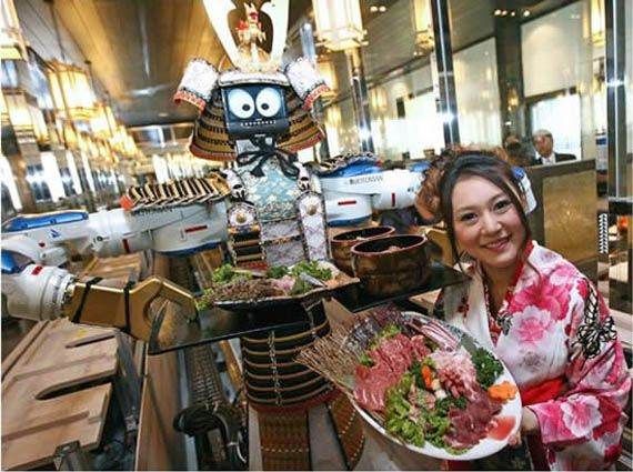 A woman served by a robot waiter at Hajime Restaurant.