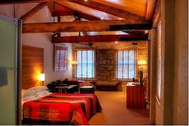 A room with wooden beams and a bed in the Henry Jones Art Hotel.