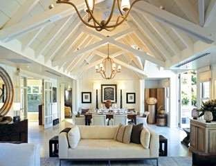 Feel the natural riverside lifestyle at The Huka Lodge, a large living room with white furniture.