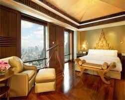 A hotel room with a large bed and a stunning view of the city, allowing you to discover Cannes in a new avatar.