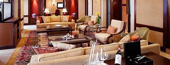 A large living room with cozy couches and a flat screen tv, perfect for relaxation.