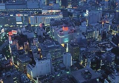 An aerial view of a city at night with stunning lights and scenery.
