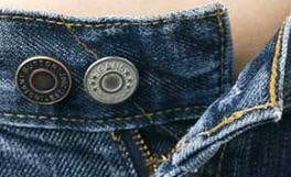 A woman's jeans with a button in the pocket, offering a one-size fits all waistband.