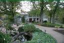 A charming inn in Jordan Hollow with a serene pond.