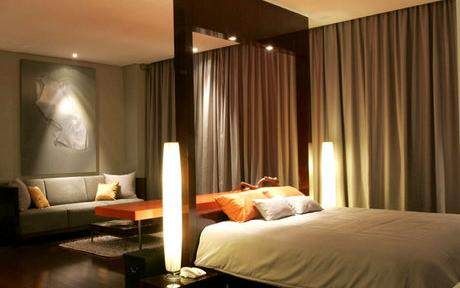 A quiet bedroom with a bed and a couch at Kemang Icon.