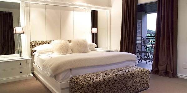 A bedroom with a bed and a dresser, ideal for relaxation.