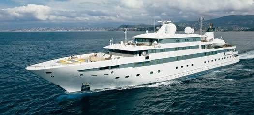 A luxurious white superyacht sailing in the ocean, offering an unforgettable holiday experience.