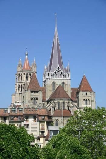 A large cathedral with spires in the background, perfect for a Swiss Girlfriend Getaway in Lausanne.