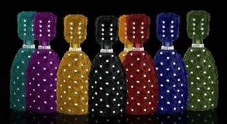 A group of different colored bottles with rhinestones on them, featuring 'Le Billionaire Champagne': The Ultimate Taste.