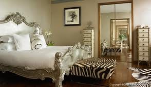 The G Hotel is the Best Place to Organize a Grand Wedding with an ornate bed and zebra print rug.