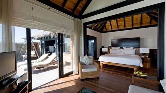 Enjoy Maldivian hospitality at The Beach House at Manafaru Maldives, overlooking the ocean from a balcony.