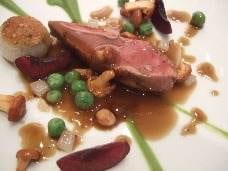 A delicious duck dish on a white plate.
