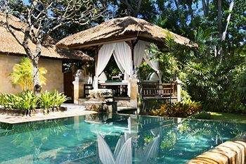 A pool surrounded by a thatched gazebo showcasing Balinese lifestyle at Melia Bali.