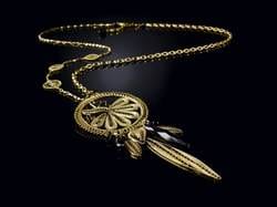 A gold dream catcher necklace.