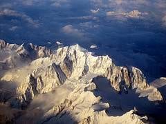 A view of snow capped mountains from an airplane during a luxurious holiday in a French Alps ski resort.
