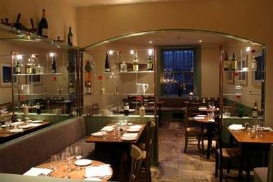 A restaurant with a glass wall offering natural flavors at The Moody Goose.