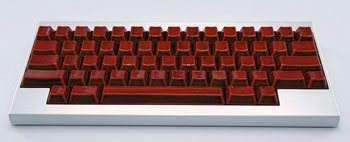 A red and silver keyboard on a white surface with a price of $4,240.