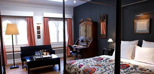 A bed or beds in a room at Hotel Nimb, beautified by historical Tivoli Gardens.