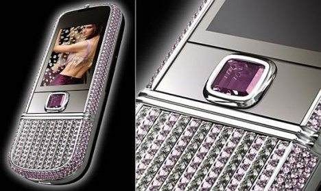 A purple cell phone with sparkling gems on it.