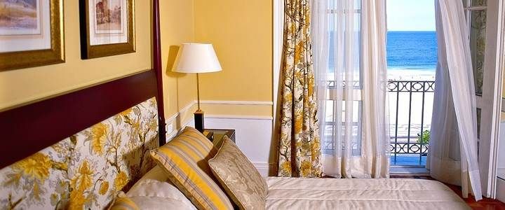 A luxurious bedroom with a balcony overlooking the ocean at the Copacabana Palace.