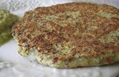 A plate with a burger and guacamole on it, the most expensive pancake in the world.