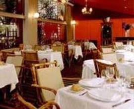 Keywords: restaurant, red walls, white tablecloths. 

Modified description: Pierre Gagnaire - A restaurant with red walls and white tablecloths for a wonderful dinner experience.