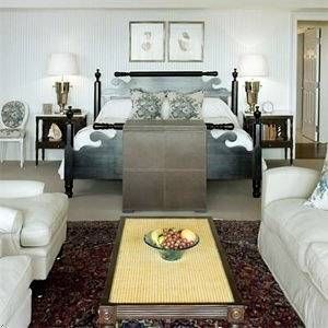 A bedroom with white furniture and a rug at the Inn at Perry Cabin along Miles River.