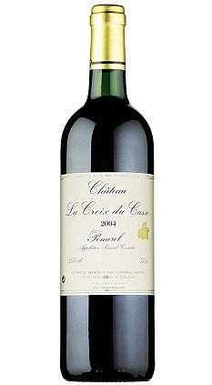 A bottle of Petrus red wine on a white background.