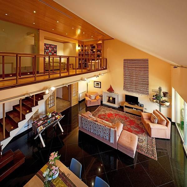 A living room with a staircase in the Dolce Vita Guesthouse Estoril.