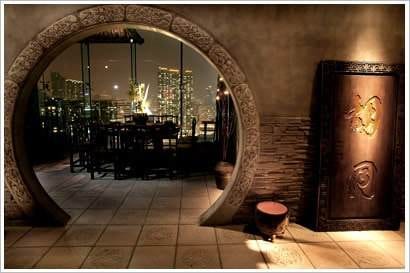 An archway with a door leading to a room with a view of the city, where you can enjoy delicious Chinese cuisine in Hutong.