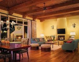 A living room with wooden beams and a fireplace at Four Seasons Resort.