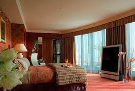 A luxurious bed with a breathtaking ocean view at the Royal Penthouse Suite of President Wilson Hotel.