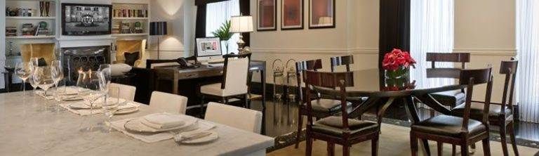 A luxurious dining room with a table and chairs.