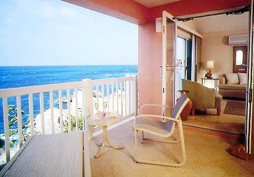 A balcony with a view of the ocean in Bermudian style at The Reefs.