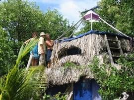 A group of people standing on top of a tree house called Spiral Island, presented by Reishee Sowa.