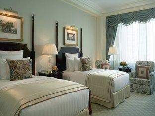 A hotel room with two beds and a large window on the top floor at The Ritz-Carlton in Beijing.