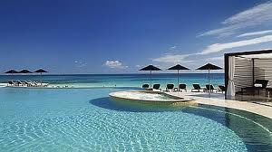 A vacation at Rosewood Mayakoba is a classic experience with lounge chairs and ocean view.