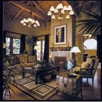 A luxury retreat in Phoenix, Arizona featuring a living room with a large chandelier.