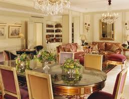 Get a 3D experience in the large living room with a dining table and chairs at Hotel Plaza Athenee in Paris.
