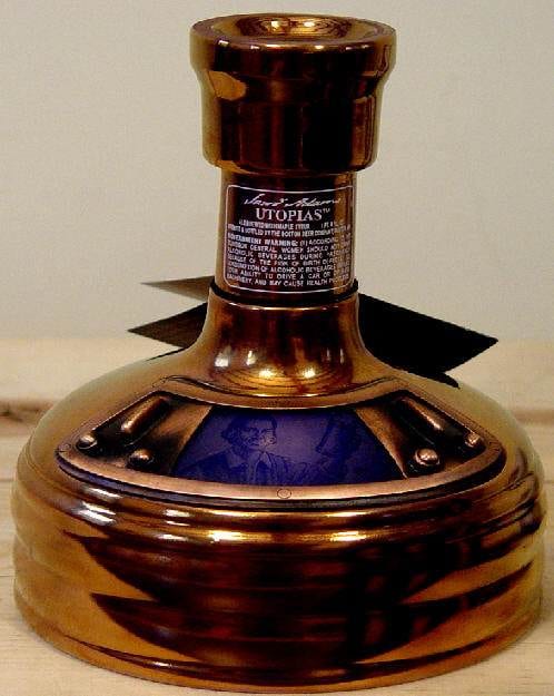 A blue and gold bottle on a wooden table featuring Samuel Adams Utopias.