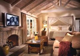 San Ysidro Ranch - A Rosewood Resort offers a bedroom with a fireplace and a bed.
