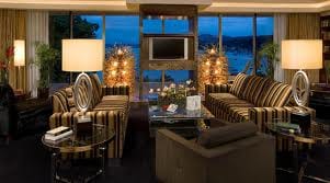 A living room with large windows overlooking a lake in Austria.