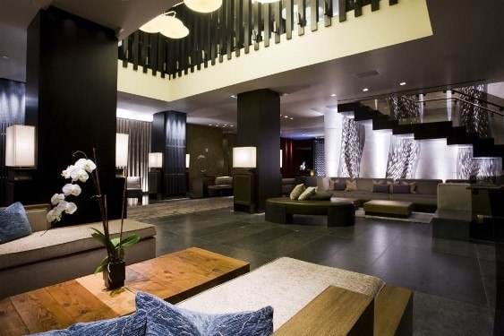 The luxurious lobby of a modern hotel with a stunning staircase.