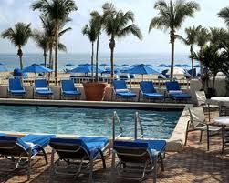 A Sheraton Hotel on the shores of Atlantic with lounge chairs and umbrellas near the beach.