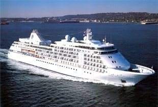 A luxurious cruise ship, Silver Whisper, gliding on the vast ocean.