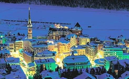 An aerial view of a city at night in St Moritz Ski Resort.